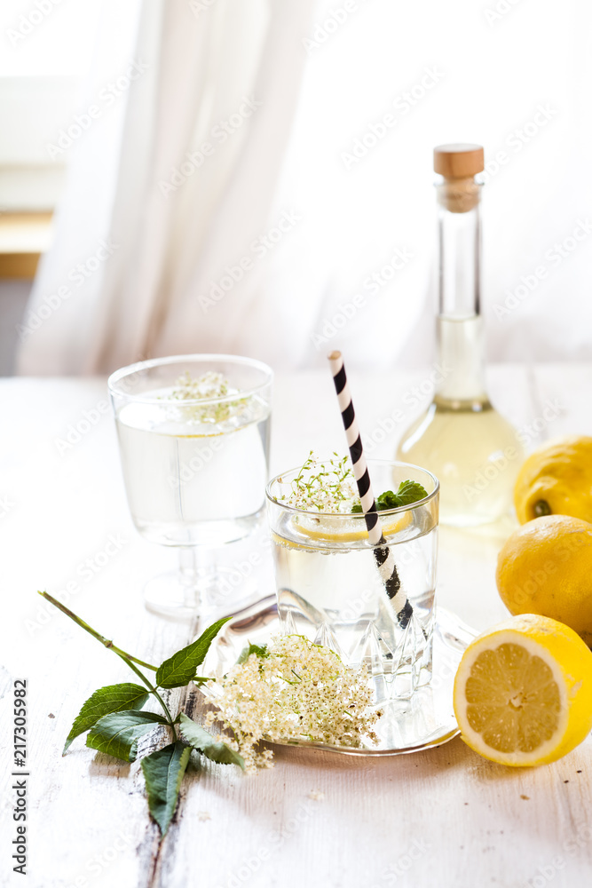 Glass of homemade elder lemonade with slice of lemon Glass of homemade elder lemonade with slice of lemon