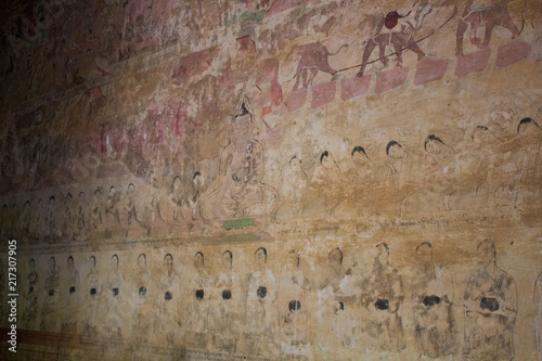 Ruined Buddha story painting on the wall photo