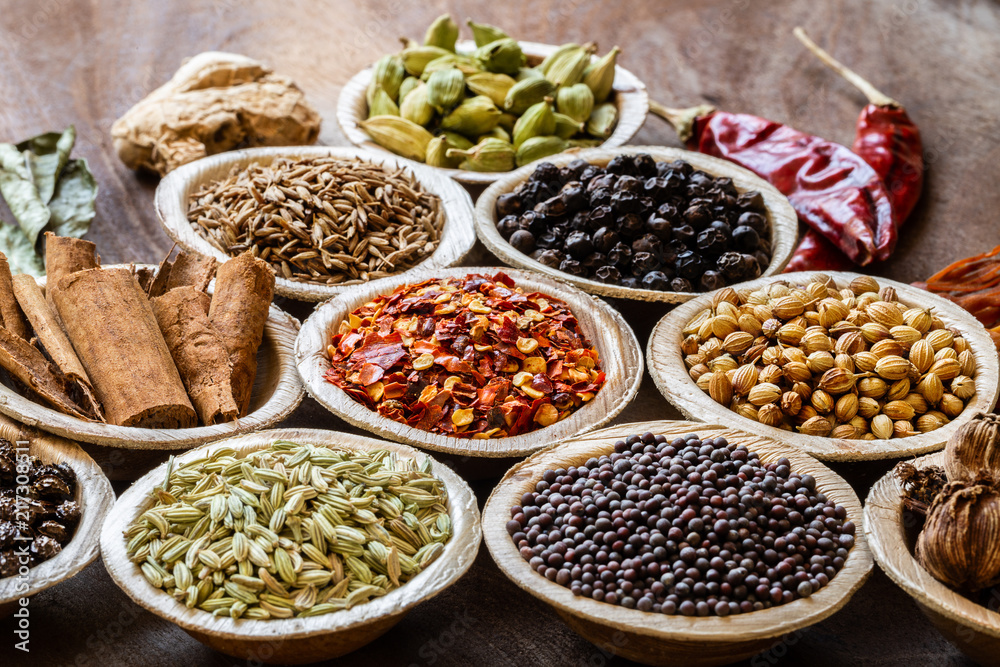 Group of Indian spices in coconut bowls on wooden background close-up Group of Indian spices in coconut bowls on wooden background close-up