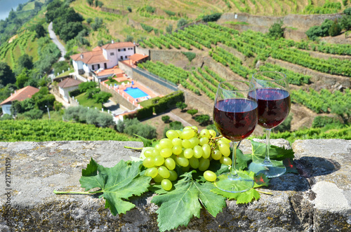 Wine glasses against vineyards in Douro Valley, Portugal