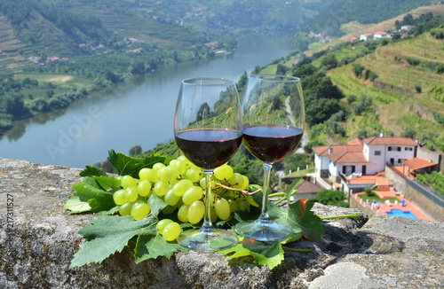 Wine glasses against vineyards in Douro Valley, Portugal