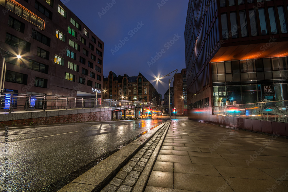 Warehouse district of Hamburg (Speicherstadt) at night. Nice reflections after rain is gone. Light trails.