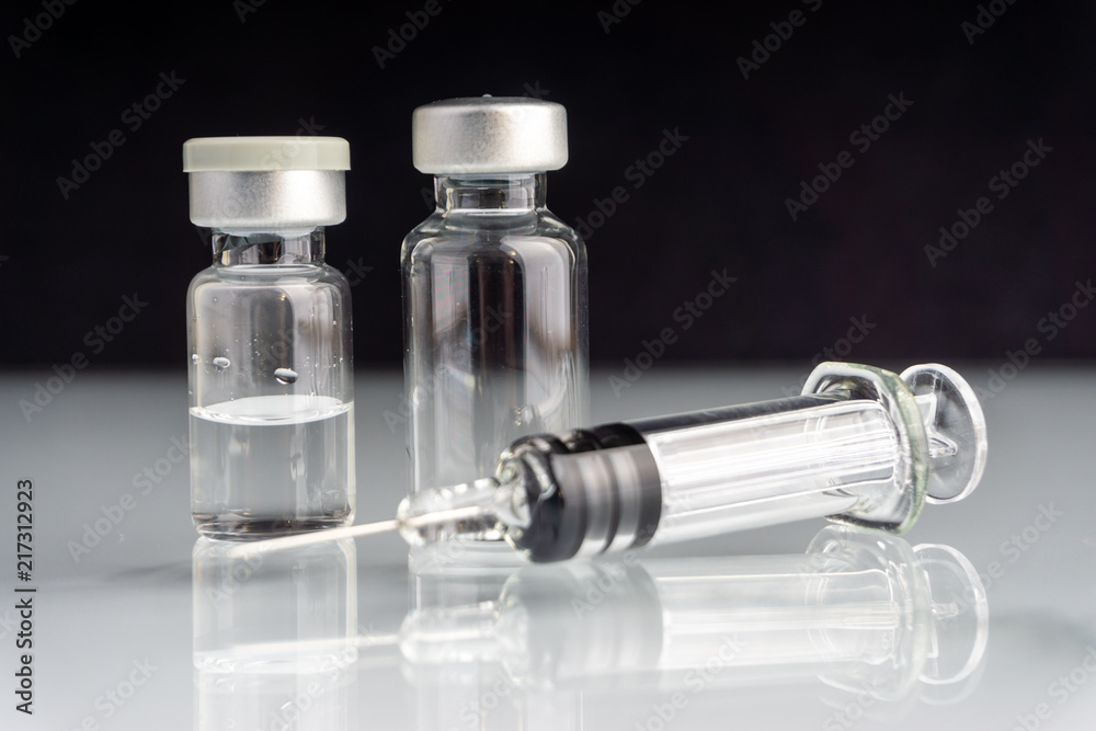 Syringe and vials closeup with selective focus and crop fragment. Medical and Healthcare Concept Syringe and vials closeup with selective focus and crop fragment. Medical and Healthcare Concept