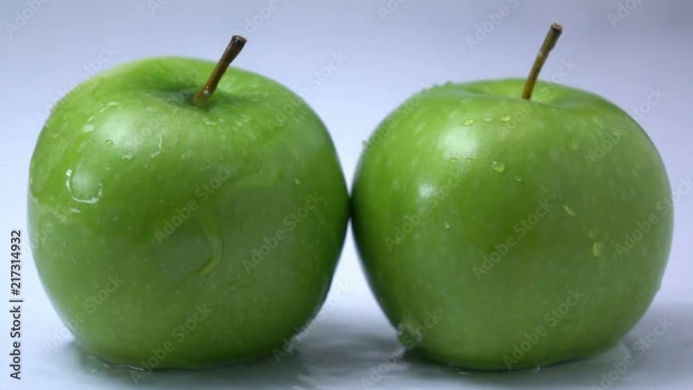water splashing on a apple fruit in slow motion. water splashing on a apple fruit in slow motion.