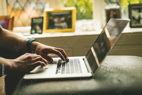 Man using laptop in living room at home photo