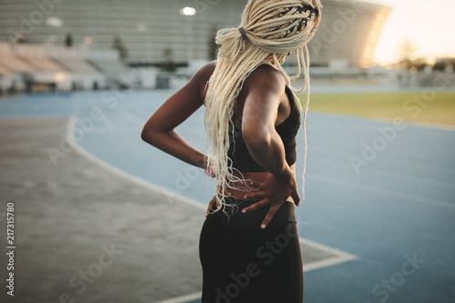 Sprinter doing warm up exercises standing in a stadium