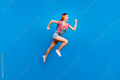 Fototapeta Naklejka Na Ścianę i Meble -  Full-size portrait of running marathon girl who looks in front o