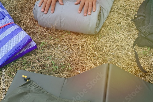 Camping equipment Sleeping bag People are rolls sleeping bags to store.