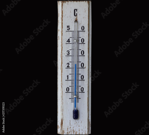 white wooden termometer on the yellow wall