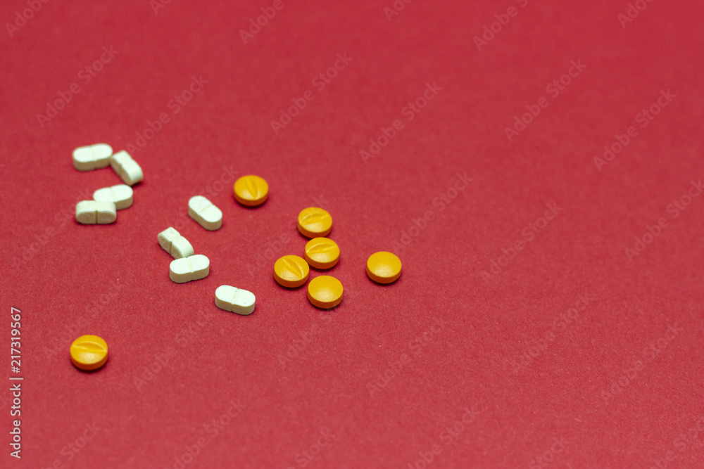 Medicine concept, pills on a red background. Medicine concept, pills on a red background.