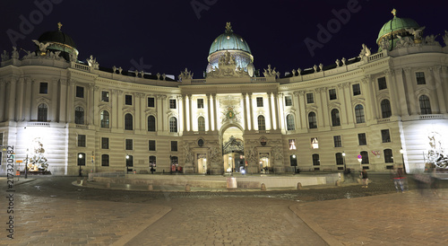 View of Hofburg illuminated at night, the imperial palace of the Habsburgs, from Michaelerplatz Vienna, Austria