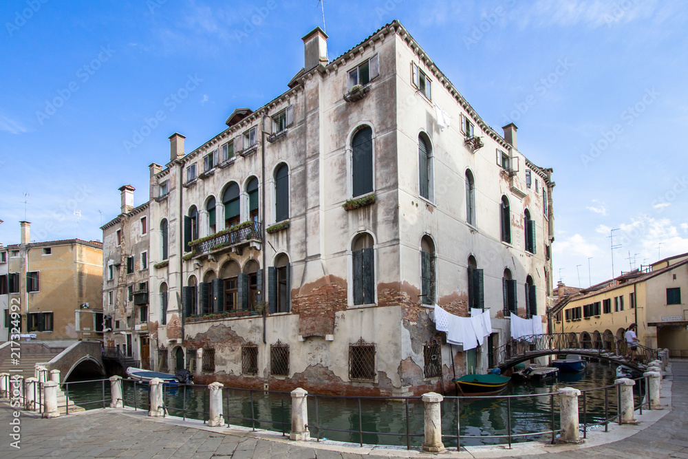 Old palace on the small canal of Venice, Italy
