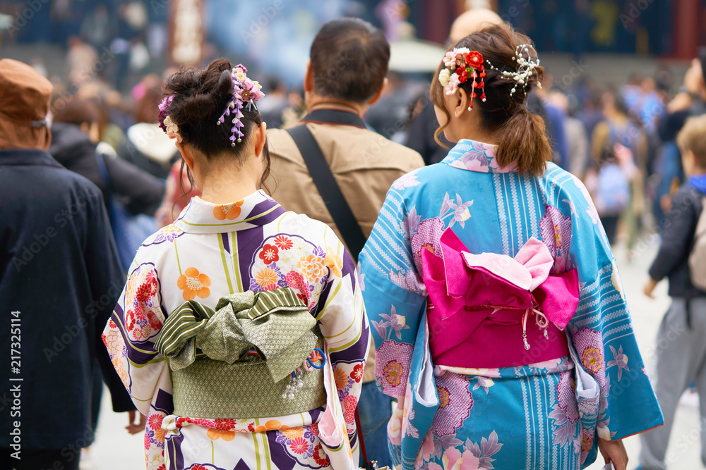 Young girl wearing Japanese kimono standing in front of Sensoji Temple in Tokyo, Japan. Kimono is a Japanese traditional garment. The word Young girl wearing Japanese kimono standing in front of Sensoji Temple in Tokyo, Japan. Kimono is a Japanese traditional garment. The word
