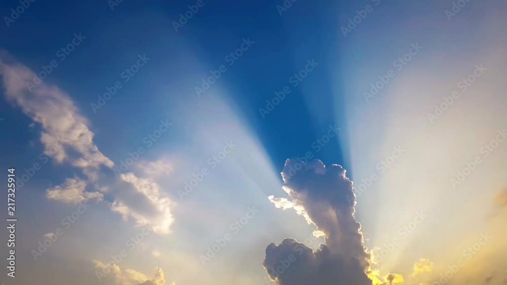 Time lapse sunbeam shine through the cloud on the blue sky . Sun rays