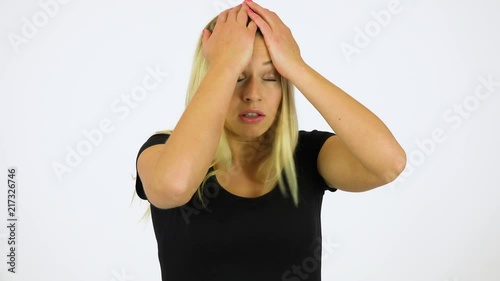 A young beautiful woman acts frustrated - white screen studio photo