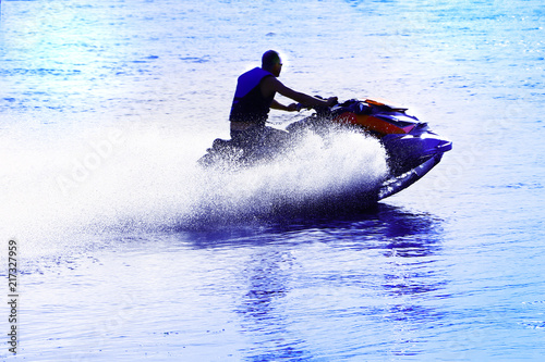 a man is riding a jetski on the water