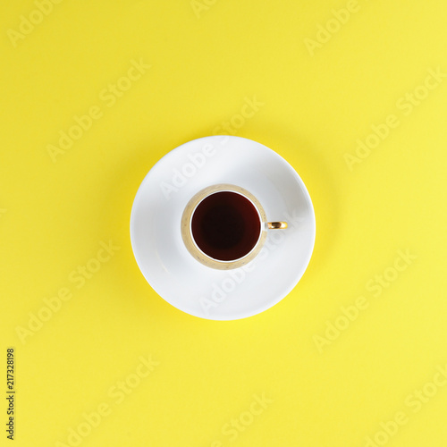 White Cup with coffee on yellow background