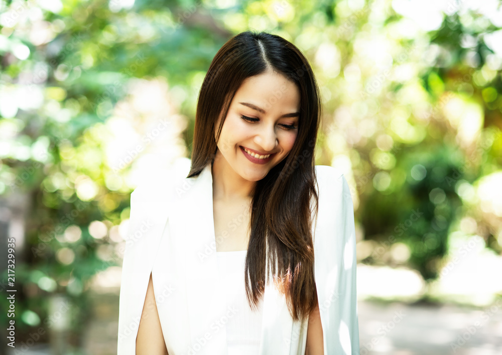 The beauty is smiling and turn face down,shyly emotion,blurry light around. The beauty is smiling and turn face down,shyly emotion,blurry light around.