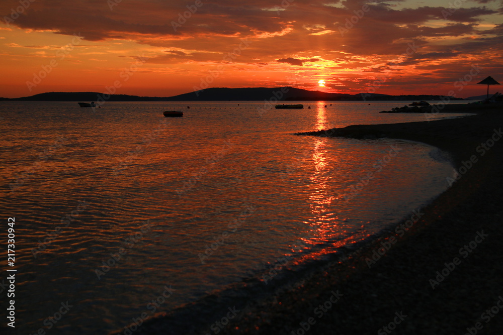 Sandy beach with sunset sky on Adriatic sea in Croatia