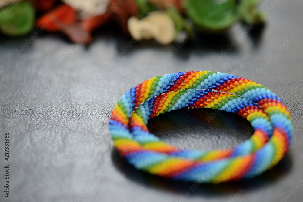 Set of rainbow bracelets for mother and daughter on a dark background close up Set of rainbow bracelets for mother and daughter on a dark background close up