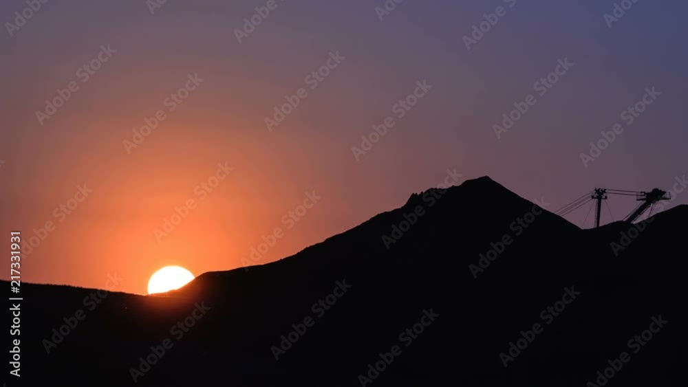 Dragline excavator loads ore at the sunset. Time lapse. Dragline excavator loads ore at the sunset. Time lapse.