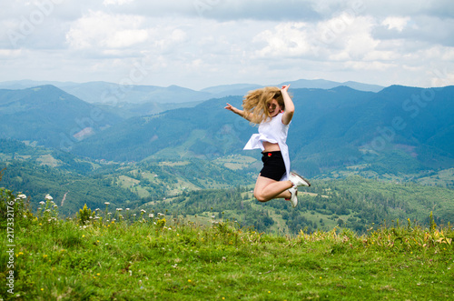 A young girl loves to travel and conquer the peaks of the mountains