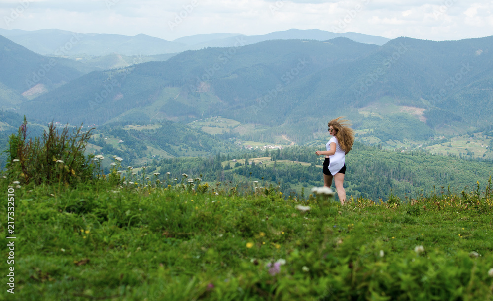A young girl loves to travel and conquer the peaks of the mountains