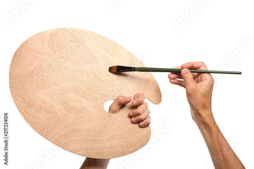 Foto Artist hands with paintbrush and empty palette, isolated on white background