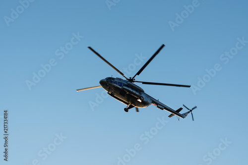 helicopter in the air against the blue sky