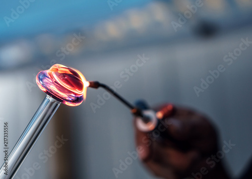 A Man Heating Glass With A Torch