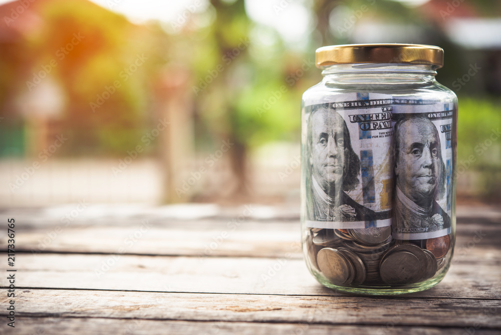 Coins in glass jar for money saving Investment and finance concept Coins in glass jar for money saving Investment and finance concept