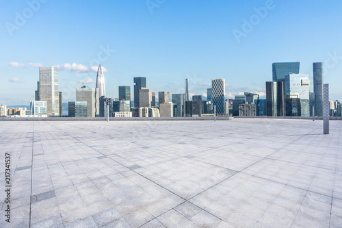 empty square with city skyline © THINK b