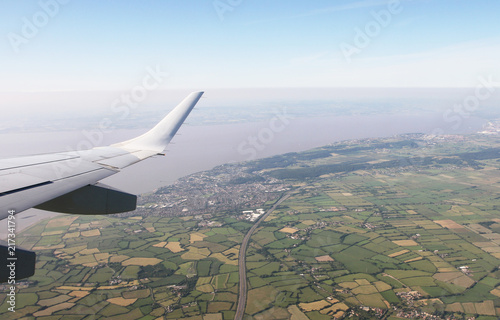 Aerial View of Bristol City Center in England, UK and surrounding fields. On the left the airplane wing.