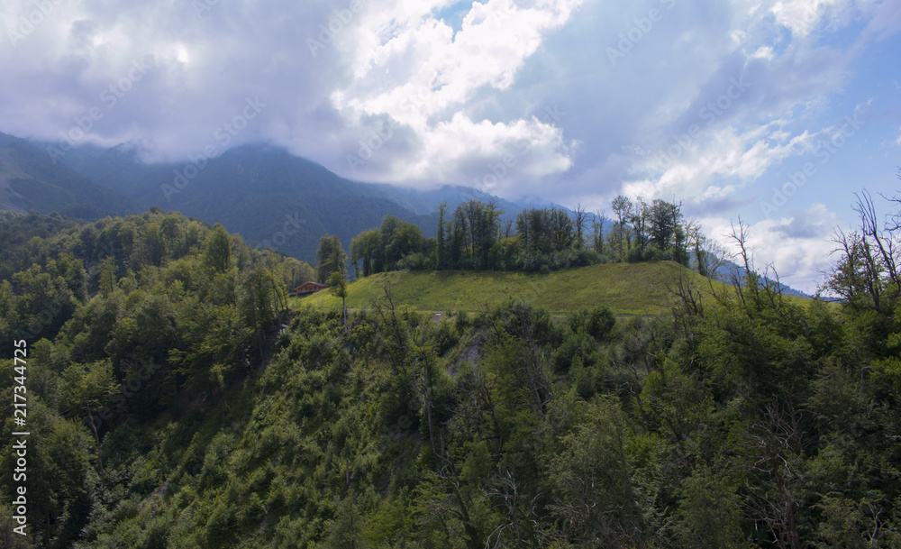 Fototapeta premium Aerial view - landscape of tree, mountain from the top of mountain a sunny cloudy day