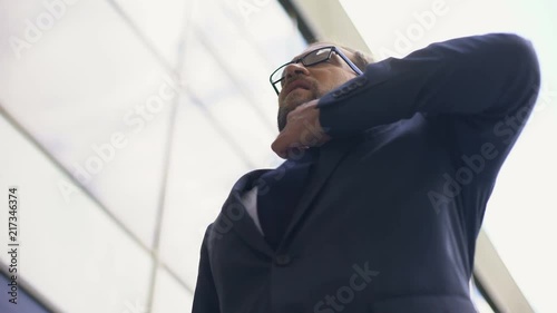 Worried office worker loosening tie, feeling chest pain, overworked manager