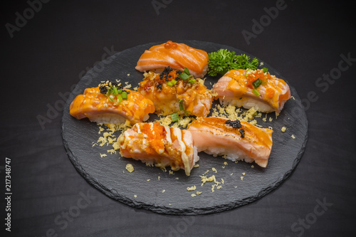 Salmon Nigiri, Sushi salmon burned and topped with Shrimp Eggs and Tempura, traditional Japanese food on ceramic dish, Japanese food, Japanese Food menu, selective focus