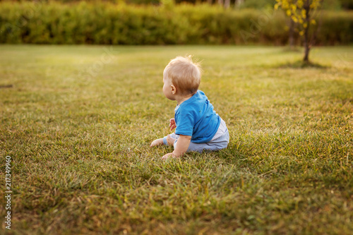 Baby first year life fun crawling on the grass. © Svitlana