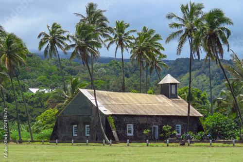 Stone church surrounded by palm trees at Keanae, a traditional Hawaiian village along the Hana Highway, Maui, Hawaii photo