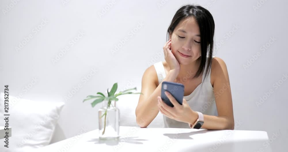 Woman use of mobile phone inside coffee shop Woman use of mobile phone inside coffee shop