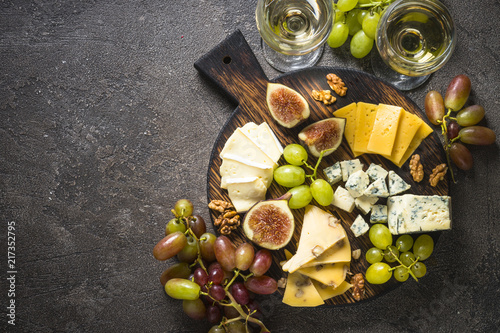 Cheese plate with grapes, figs and nuts. photo