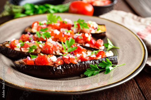 Baked eggplants with tomatoes, onion and garlic