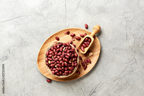 Bowl of fried peanut and scoop with copy space. Top view. photo