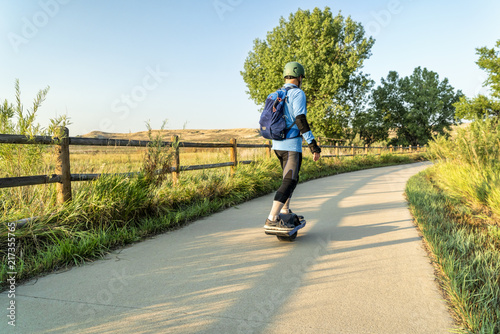 riding electric skateboard on bike trail