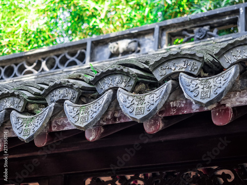 Traditional chinese building with ornate roof and red windows at Yu Gardens, Shanghai, China