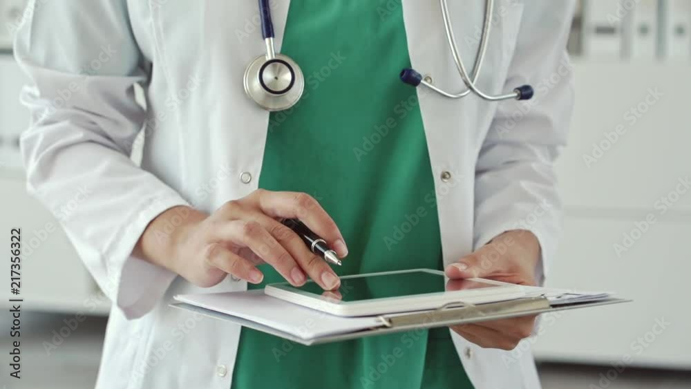 Female doctor working on tablet Female doctor working on tablet