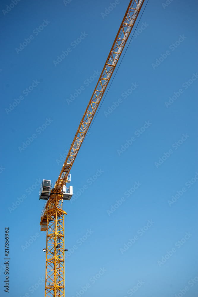 Naklejka premium Construction Crane and Clear Blue Sky