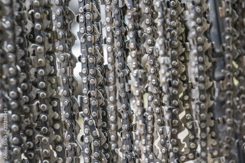 Hanging chainsaw cutting chains  selective focus  texture background