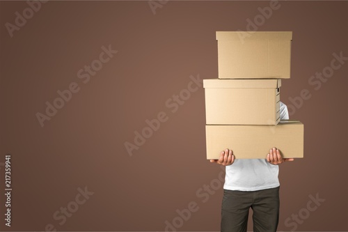 Man with cardboard boxes on background
