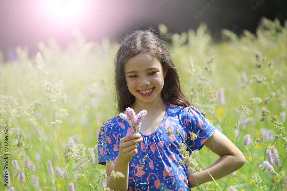 Ein Mädchen steht in einer wilden Blumenwiese im Thüringer Wald Ein Mädchen steht in einer wilden Blumenwiese im Thüringer Wald
