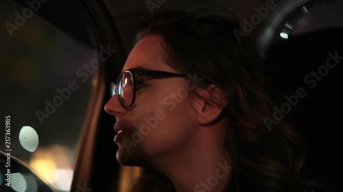 Woman looking out car window at night. Woman starring at city lights2 photo